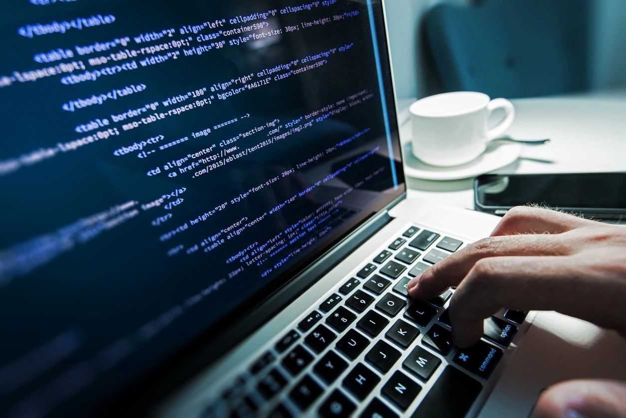 Developer working on code at a laptop